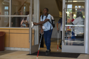student who is blind or visually impaired participates in cane quest