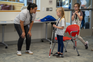 student who is blind or visually impaired participates in cane quest