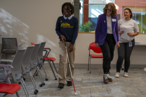 student who is blind or visually impaired participates in cane quest