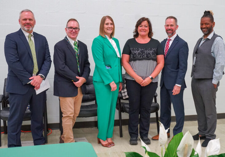 teacher is recognized by administration for her completion of the BridgeUp Teach program